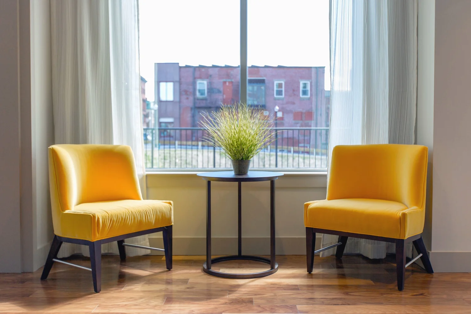 Two yellow chairs by a sunlit window